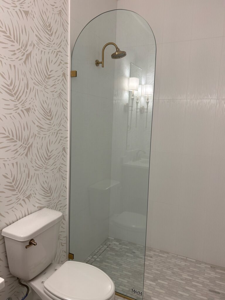 M&M Glass Company half-moon custom shower panel 